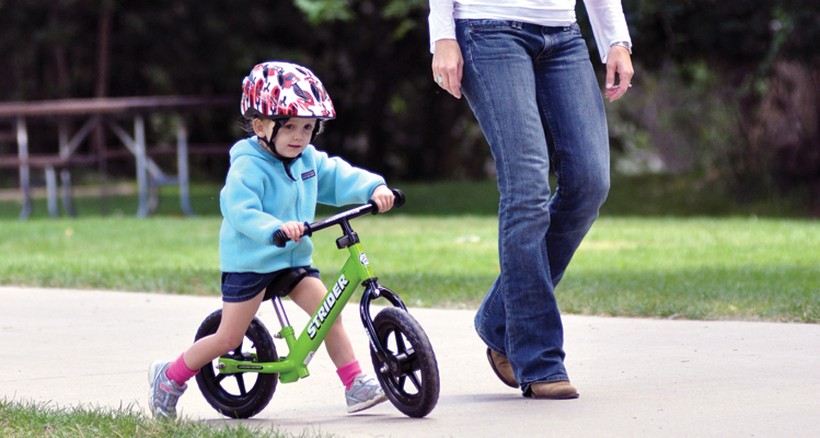 kid on strider bike