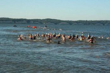 The female triathletes head into the water.