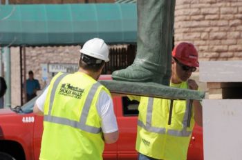 Workers carefully guided the 10-foot bronze to a 5-foot pedestal on the corner of Fifth and Phillips.