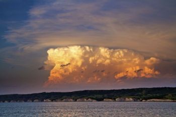 The last light of the day colors a thundercloud above the Missouri River north of Chamberlain.