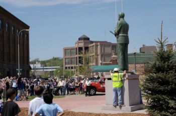 Students, families and downtown workers turned out during their lunch hour to watch the statue dedication.