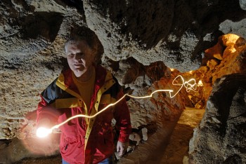 In a self-portrait of sorts, photographer Chad Coppess
creates a trail of light in Black Hills Caverns. Photo by Chad Coppess / S.D. Tourism.