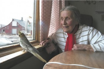 Katharina Redlin, pictured here with one of the cockatiels she raised and sold, found a peaceful life waiting for her in Summit.
