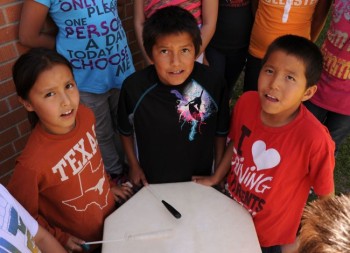 The survival of Lakota culture depends on the young. Last spring, students at North Elementary in Mission (Allen Antelope, Jeff Mandan and Loren White Hat) learned the Lakota flag song for their school's wacipi. Photo by Bernie Hunhoff.