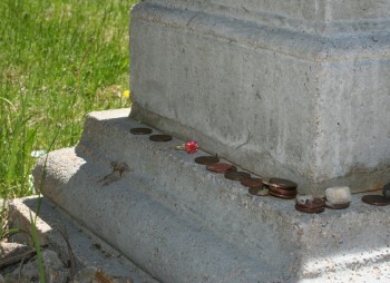 Many visitors leave coins and trinkets throughout the cemetery.