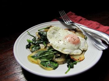 The runny yellow yolk of a fried egg perfectly compliments Fran Hill's earthy potato and spinach hash.