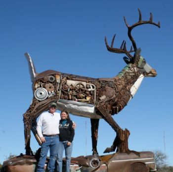 Brett and Tammy Prang beside Scrappy, their 17-foot metal deer. Tammy Prang photo.