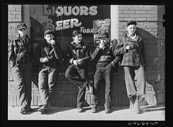 'Younger boys are standing in front of pool halls this year.' This photo, taken by John Vachon in 1942 in Roscoe, SD, is part of the Library of Congress prints and photographs collection.