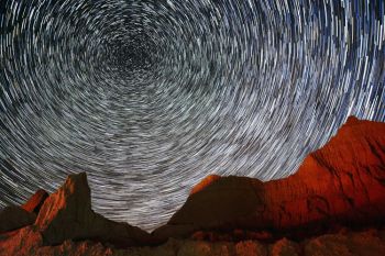 Multiple images combined of the stars above the Badlands show star trails as they move around Polaris (The North Star) in the northern sky.