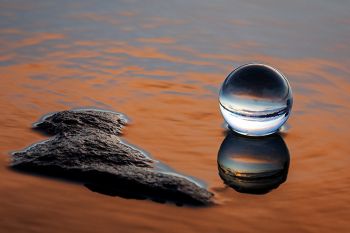 The lens ball resting on a rock on the edge of Lake Vermillion just after sunset.