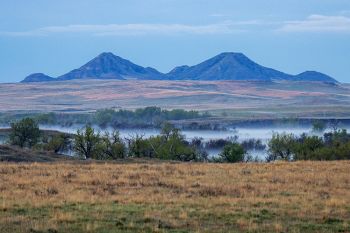 Deers Ears Buttes with early morning fog over the south fork of the Moreau River.