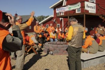 Father Vogel prays over the hunters before the hunt begins.