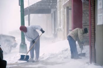 John Dangel (left) and other downtown Freeman store owners labored to keep their sidewalks open.