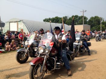Vietnam veterans ride motorcycles through the parade.
