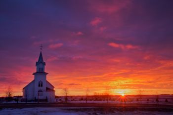 Highland Church with the rising sun.