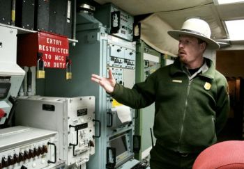 A National Park Service employee points to the double-locked red box that concealed the code and keys for a missile launch at the <a href='http://www.nps.gov/mimi/index.htm' target='_blank'>Minuteman Missile National Historic Site</a>. 2007 photo by Paul Higbee.