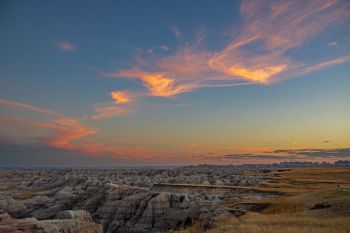 Sunset colored clouds over the eastern reaches of Badlands National Park.