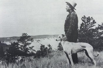 Berry with his greyhound at his side, gazing over his Badlands ranch.